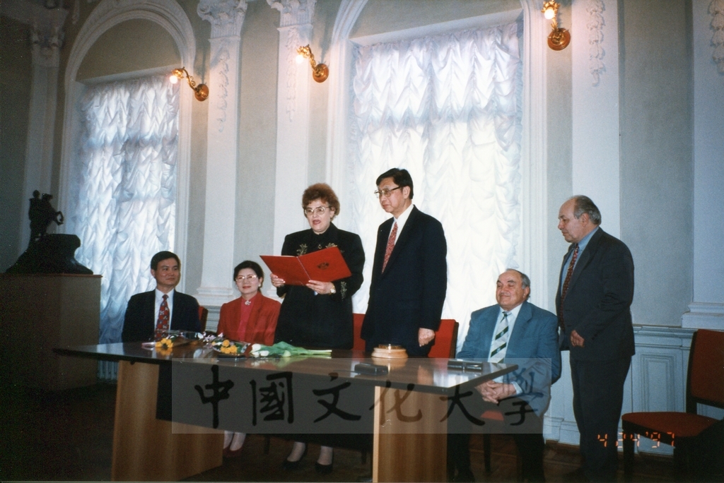 1997年4月23日及24日董事長張鏡湖帶領校長林彩梅、學務長高輝、俄研所所長明驥及國際學術合作組組長孫德宜拜會俄羅斯聖彼得堡大學，張董事長並榮獲該校名譽博士學位，由該校校長薇爾碧芝卡雅女士親自頒贈的圖檔，第6張，共32張